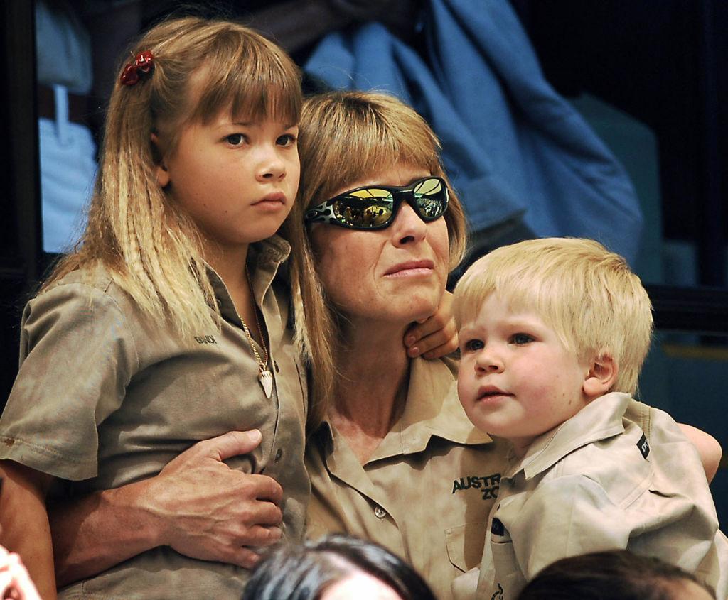 Terri Irwin comforts Bindi and Robert at a memorial service for Steve Irwin at Australia Zoo in Beerwah, Australia, on Sept. 20, 2006. (©Getty Images | <a href="https://www.gettyimages.com/detail/news-photo/terri-irwin-wife-of-australian-environmentalist-and-news-photo/71942900?adppopup=true">Pool</a>)