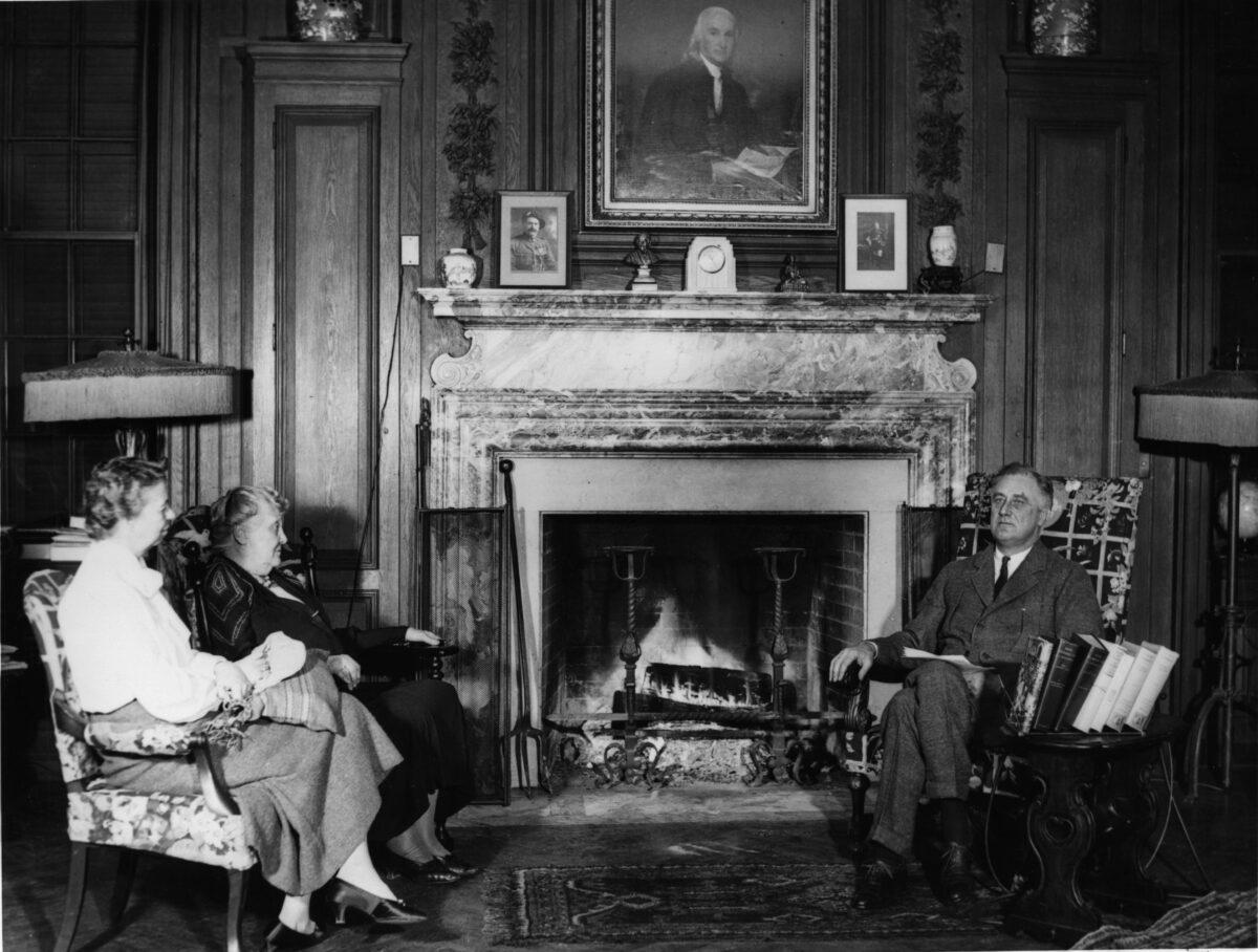 President Franklin Delano Roosevelt addresses the nation over a national radio hook-up, while Eleanor Roosevelt and the president's mother, Sarah, sit watching on the other side of the fireplace. (Keystone/Getty Images)