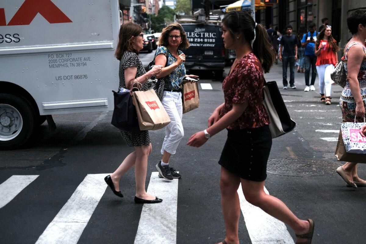 People walk along a shopping street in lower Manhattan in New York City on July 05, 2019. (Spencer Platt/Getty Images)