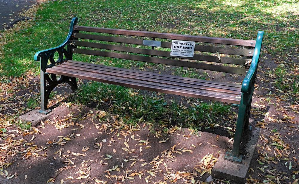 A “Happy to Chat” bench in Ashcombe Park, part of an initiative by Avon and Somerset police departments to tackle loneliness and isolation in the community (©Shutterstock | <a href="https://www.shutterstock.com/image-photo/westonsupermare-uk-july-25-2019-bench-1461418352">Keith Ramsey</a>)