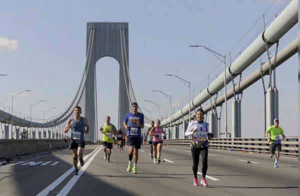 Runners make their way across the Verrazano-Narrows Bridge during the start of the New York City Marathon on Nov. 3, 2019. (Julius Motal/AP Photo)