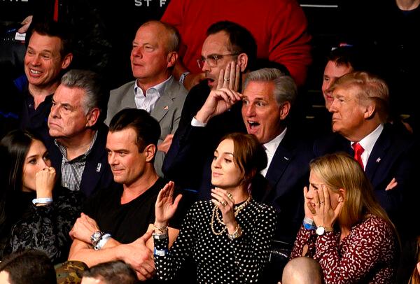 President Donald Trump (R) flanked by House Minority Leader Kevin McCarthy (2R) react as they watch the Ultimate Fighting Championship at Madison Square Garden in New York City, N.Y., on Nov. 2, 2019. (Andrew Caballero-Reynolds/AFP via Getty Images)
