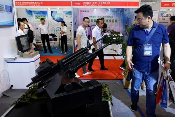 People visit the Chinese Defense Information Equipment and Technology exhibition in Beijing on June 18, 2019. ((Wang Zhao/AFP via Getty Images)