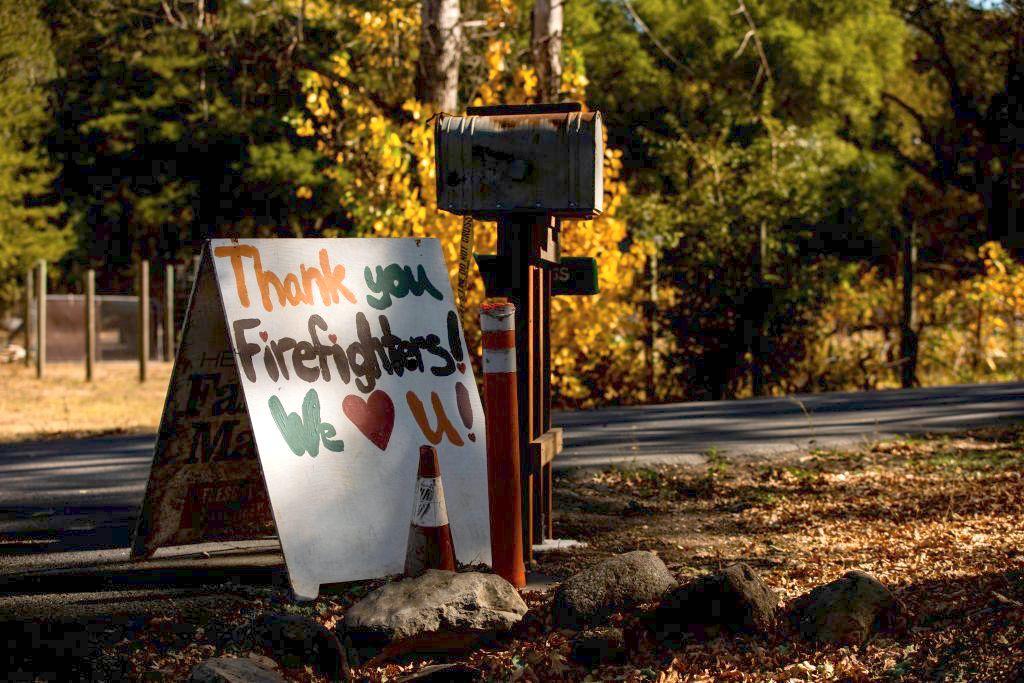 A hand-painted sign thanking firefighters sits in front of a house along Alexander Valley Road in Geyserville on Oct. 31, 2019. (©Getty Images | <a href="https://www.gettyimages.com.au/detail/news-photo/sign-thanking-firefighters-sits-in-front-of-a-house-along-news-photo/1179237447">PHILIP PACHECO/AFP</a>)