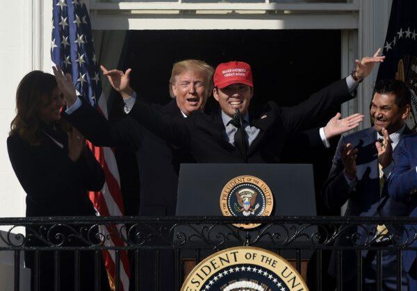 US President Donald Trump reacts as player Kurt Suzuki wears a "Make America Great Again" baseball hat during a ceremony to welcome the 2019 World Series Champions, the Washington Nationals, on the South Lawn of the White House in Washington, D.C., November 04, 2019. (Photo by Olivier Douliery/AFP via Getty Images)