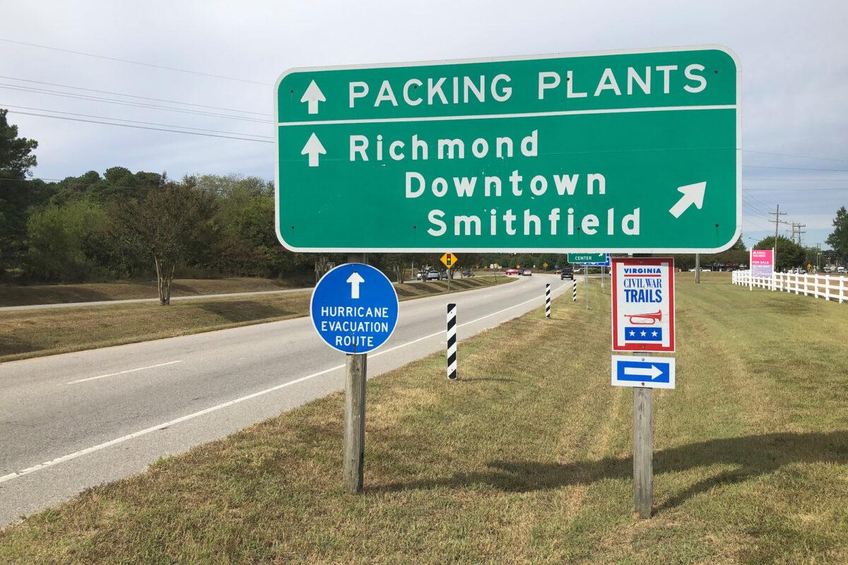 A road sign directs traffic to the Smithfield Foods pork processing facilities in Smithfield, Va., on Oct. 17, 2019. (Tom Polansek/Reuters)