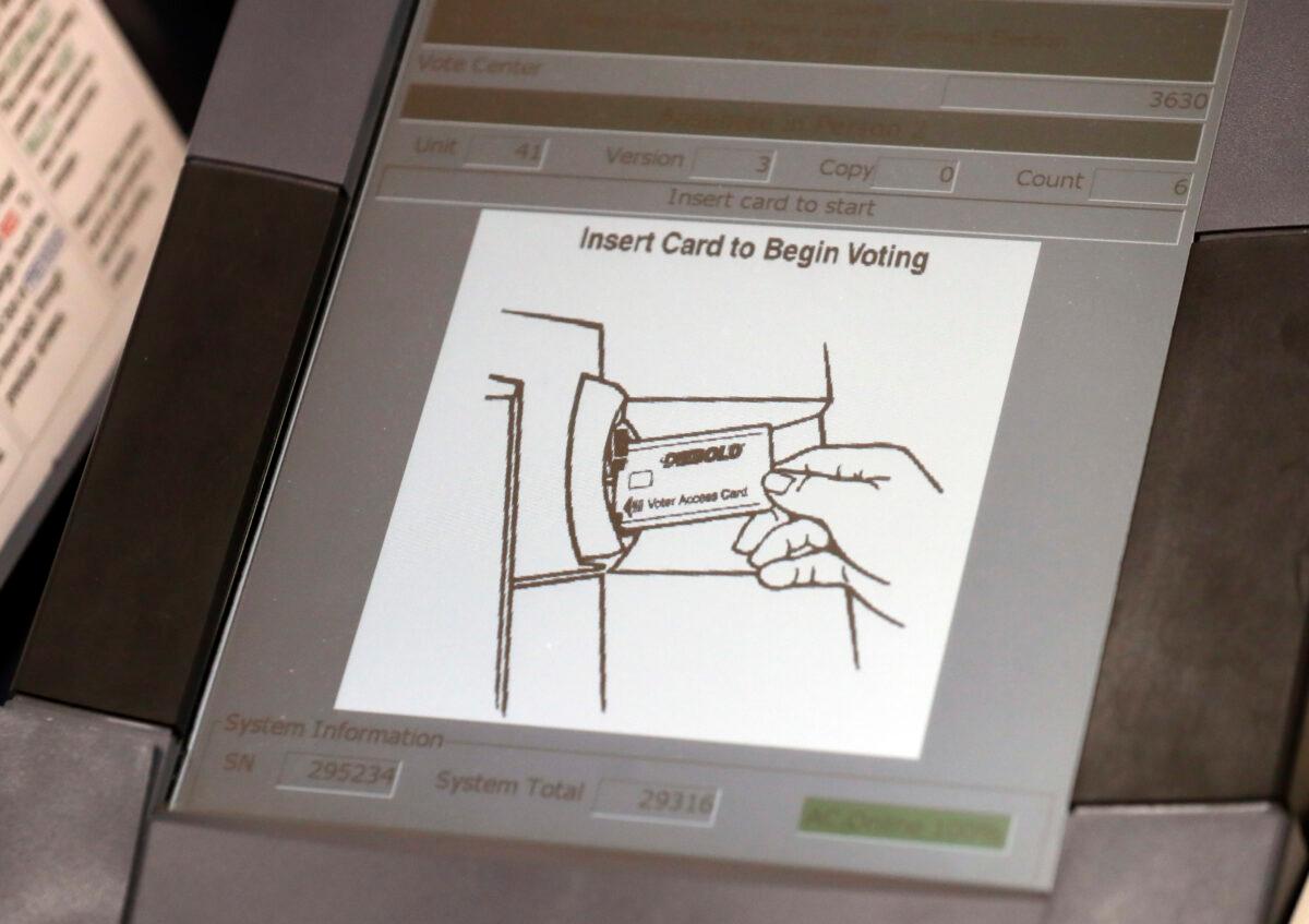 This May 9, 2018, photo shows a touch screen of a voting machine during early voting in Sandy Springs, Ga. AP Photo/John Bazemore, File