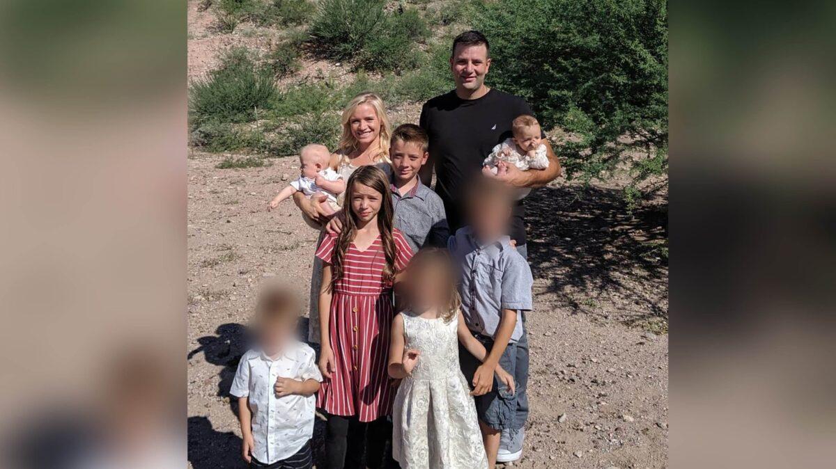 Howard Miller, the man in the black shirt, and the three children with blurred faces survived the attack. The five others were killed. (Family Handout)