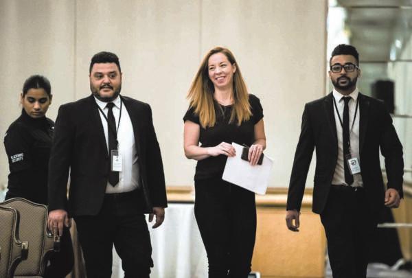 Writer Meghan Murphy (2nd R) walks with security before speaking during a panel discussion on gender identity in Vancouver on Nov. 2, 2019. (Darryl Dyck/The Canadian Press)
