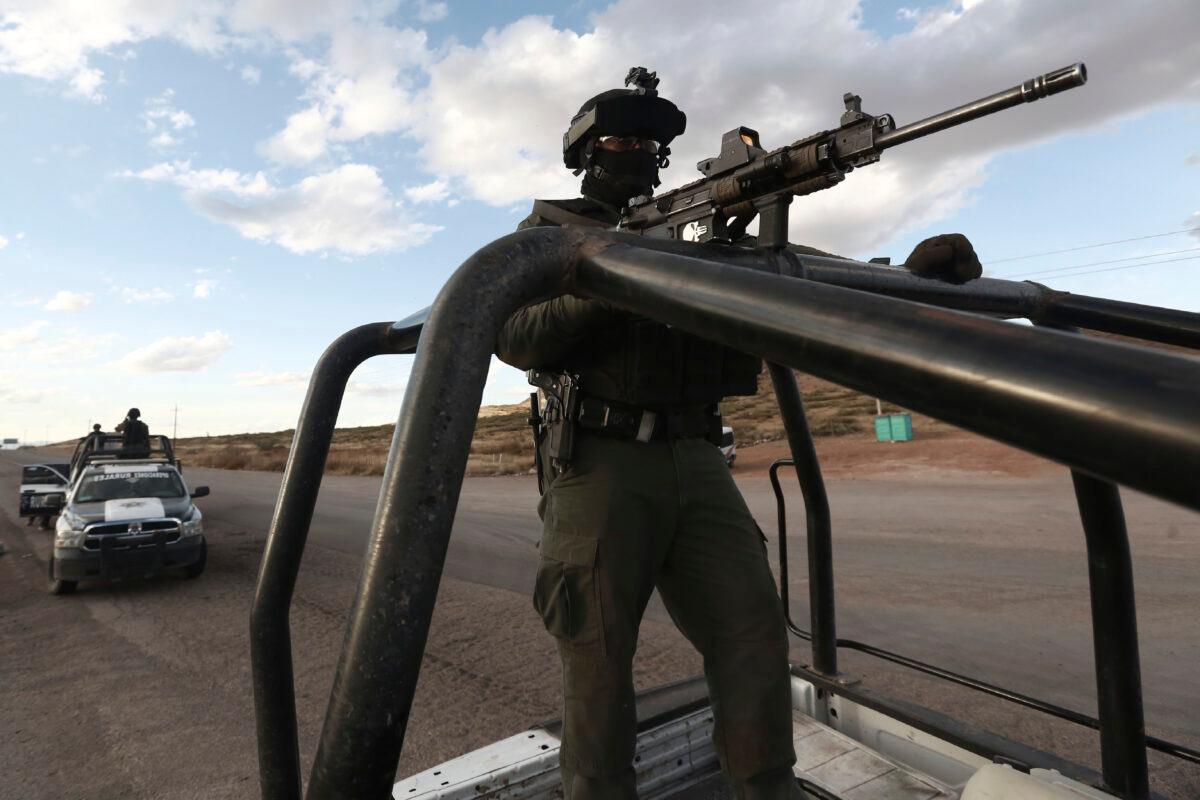Chihuahua state police officers man a checkpoint in Janos, Chihuahua state, northern Mexico on Nov. 5, 2019. (AP Photo/Christian Chavez)