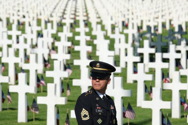 A member of the U.S. Army Europe band stands among graves at Normandy American Cemetery on the 75th anniversary of the World War II Allied D-Day invasion, near Colleville-Sur-Mer, France, on June 6, 2019. (Sean Gallup/Getty Images)