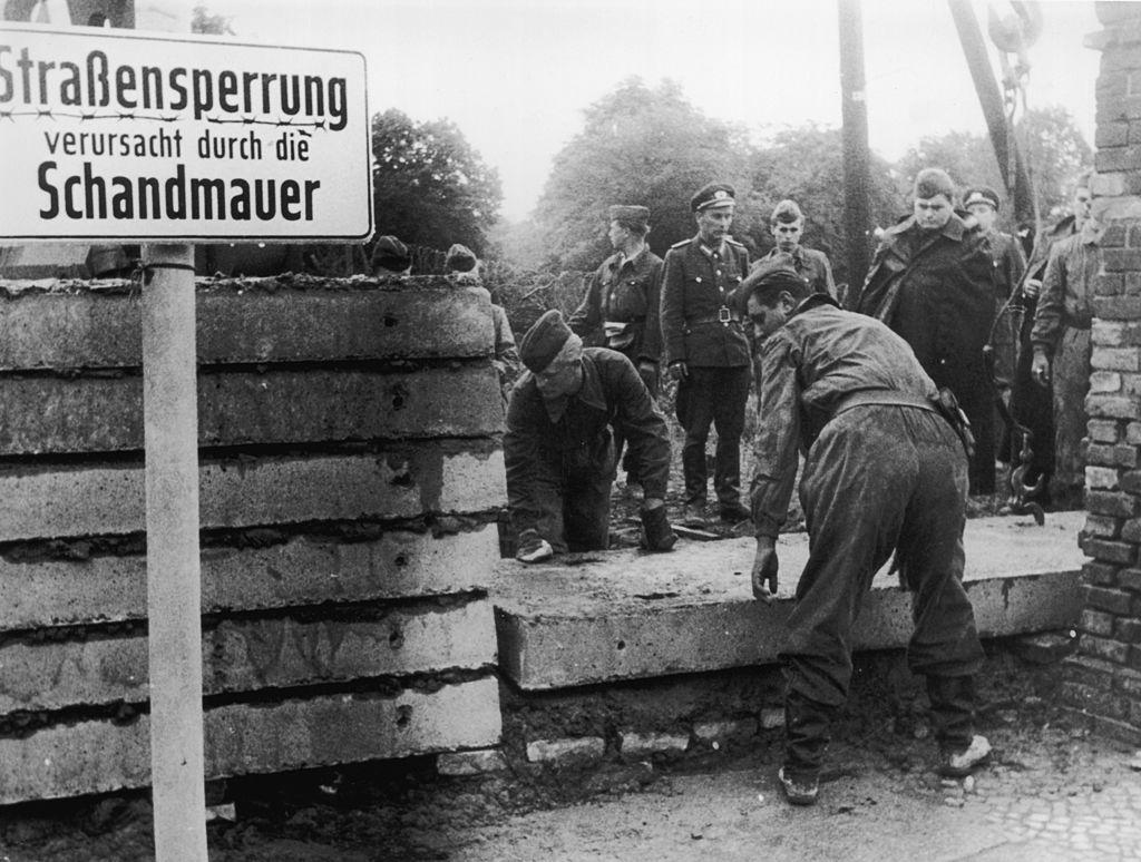 Soldiers building the Berlin Wall as instructed by the East German authorities, in order to strengthen the existing barriers dividing East and West Berlin, in 1961. (Keystone/Getty Images)
