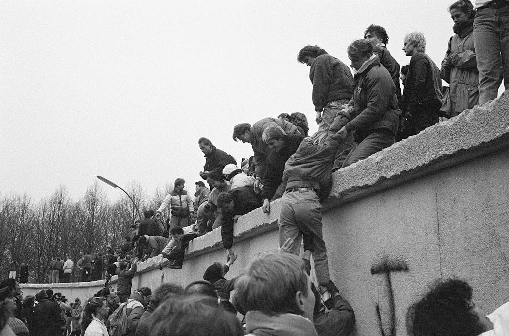 East Berliners climb onto the Berlin Wall to celebrate the effective end of the city's partition, Dec. 31, 1989. (Steve Eason/Hulton Archive/Getty Images)