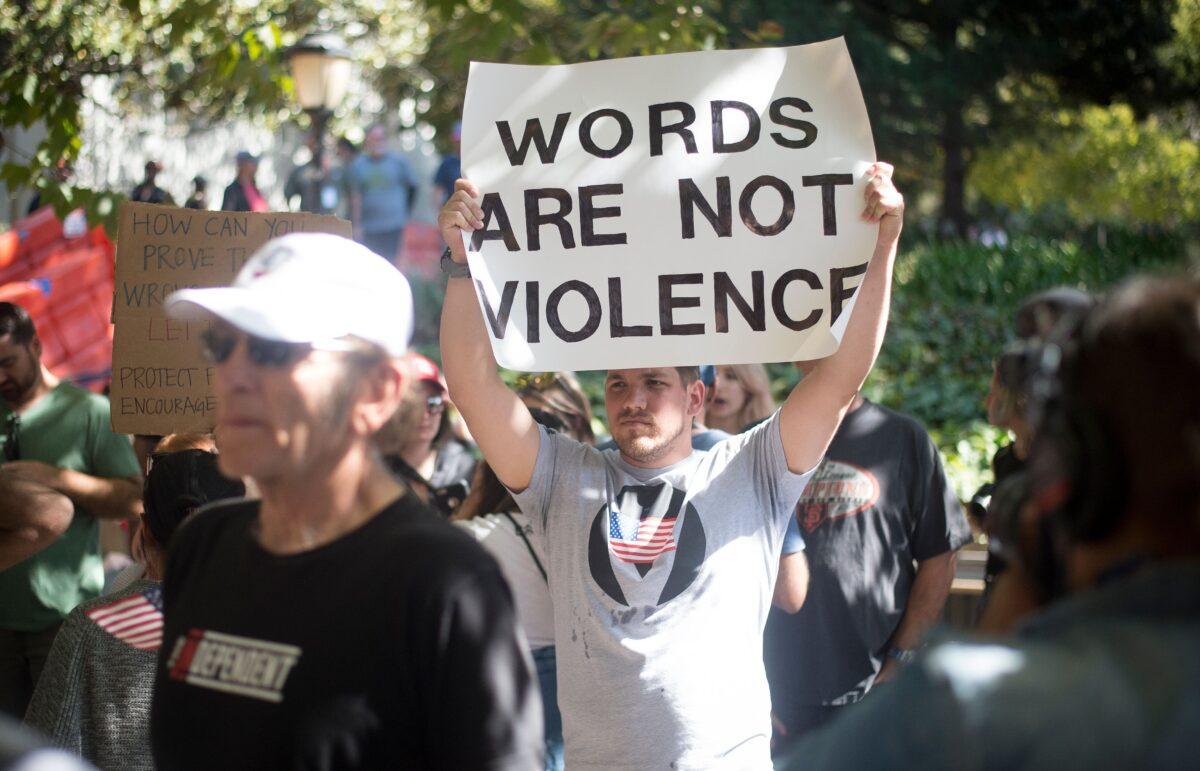 Counter-protesters hold up signs while waiting for conservative commentator Milo Yiannopoulos to arrive at the University of California, Berkeley campus on Sept. 24, 2017. Although a student group cancelled plans for Free Speech Week, Yiannopoulos was able to speak on campus, surrounded by a heavy police presence. (Josh Edelson/AFP via Getty Images)