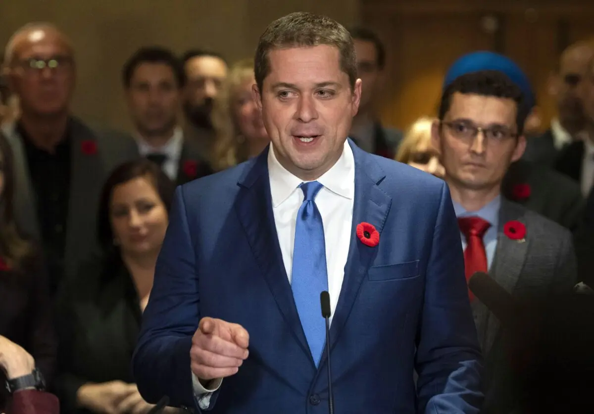 Then-Conservative Leader Andrew Scheer is surrounded by members of his caucus as he speaks to reporters following a caucus meeting on Parliament Hill in Ottawa on Nov. 6, 2019. (The Canadian Press/Justin Tang)