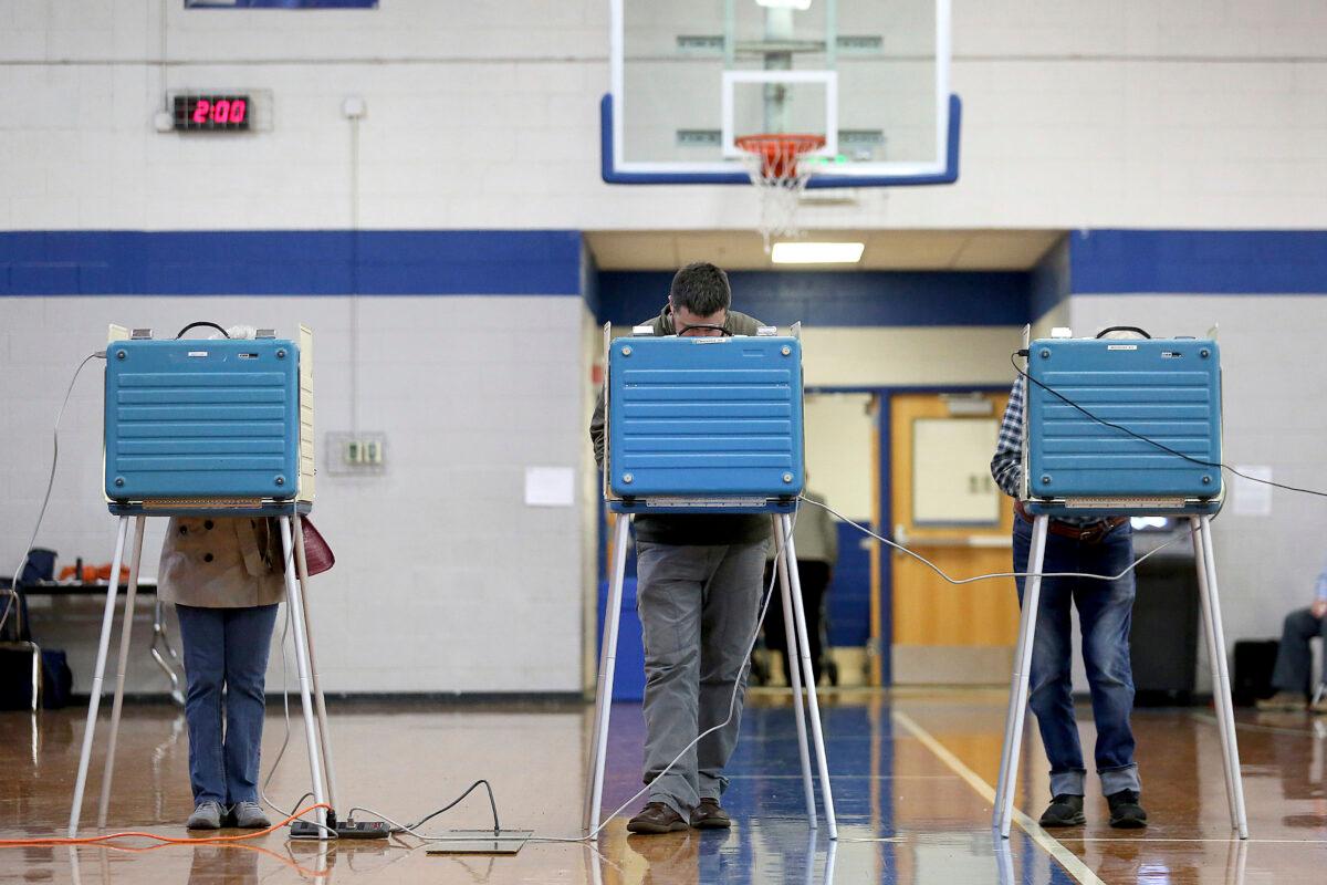 Voters cast ballots in the gym at York High School in Virginia on Nov. 5, 2019. (Rob Ostermaier/The Daily Press via AP)