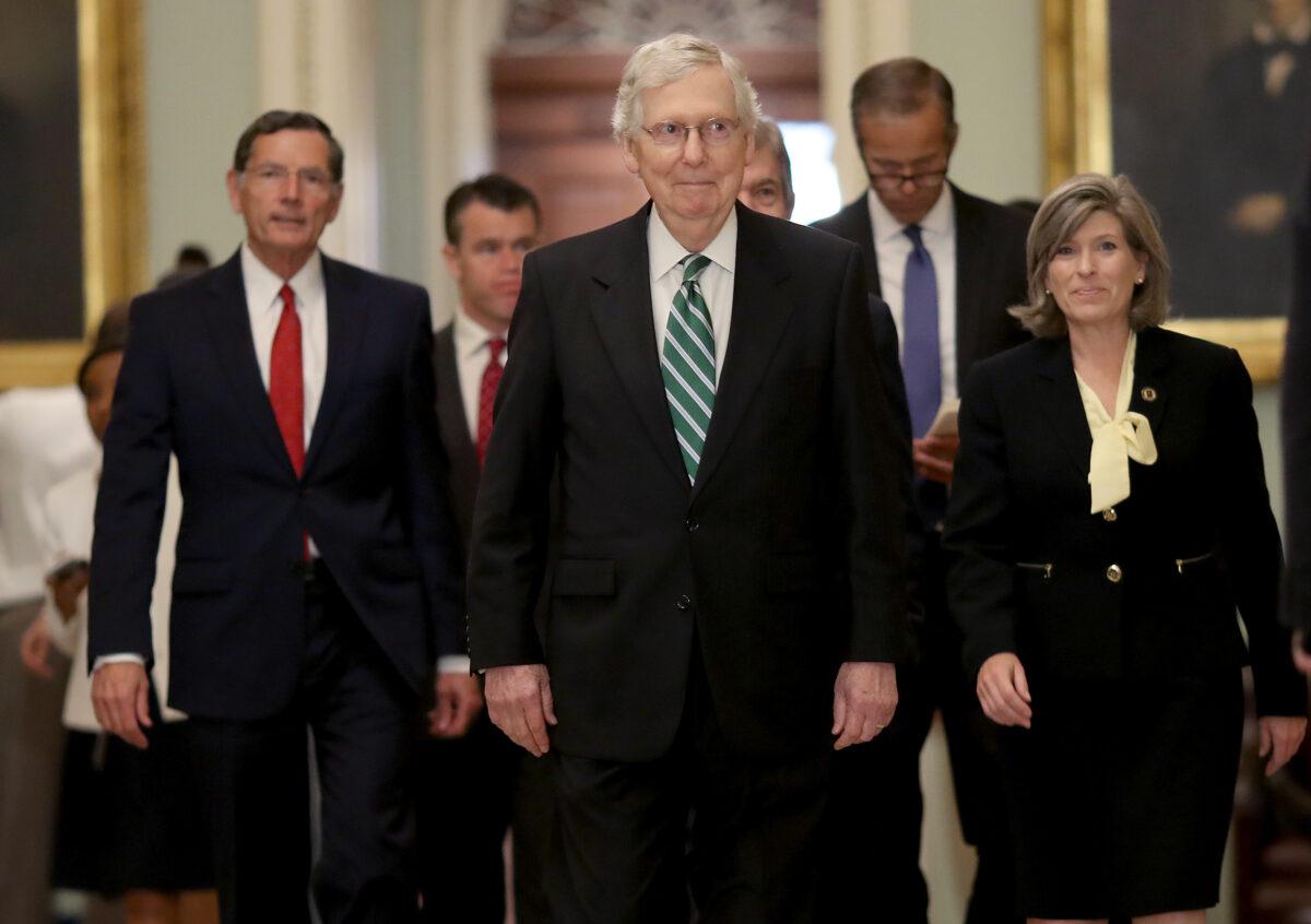 Senate Majority Leader Mitch McConnell (R-Ky.) (C) walks to a press conference with fellow Republicans following the weekly Republican policy luncheon in Washington on July 30, 2019. (Win McNamee/Getty Images)