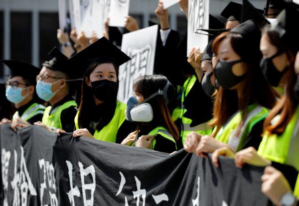 Graduates wearing masks hold an anti-government rally after their graduation ceremony at the Chinese University of Hong Kong in Hong Kong, China on Nov. 7, 2019. (Kim Kyung-Hoon/Reuters)