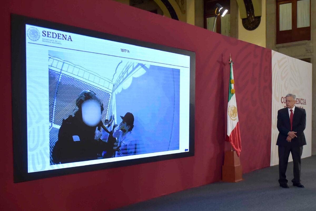 In this handout photo provided by Mexico's Presidential Press Office, President Andres Manuel Lopez Obrador watches a video that shows the capture of Ovidio Guzman Lopez, a son of Joaquin "El Chapo" Guzman, who was then released, during the daily press conference at the National Palace in Mexico City on Oct. 30, 2019. (Mexico's Presidential Press Office via AP)