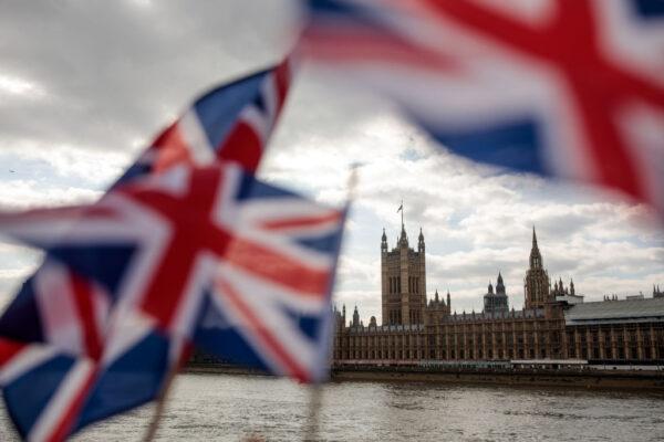 Union Jack flags flutter in the wind in front of the Houses of Parliament in Westminster in London on March 26, 2019. (Jack Taylor/Getty Images)