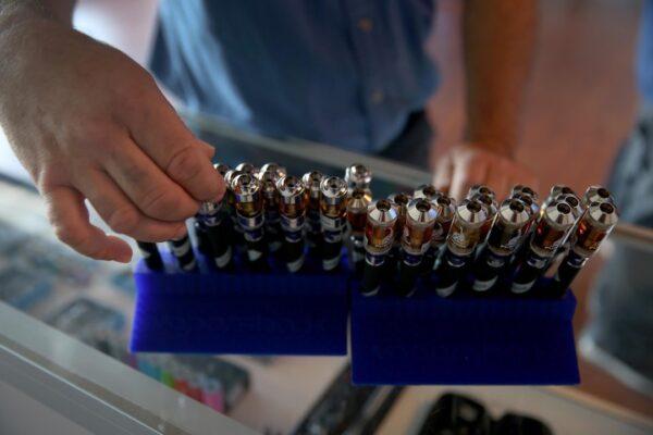 A customer picks from different flavors of electronic cigarette vapor as they shop at the Vapor Shark store in Miami, Fla., on April 24, 2014. (Joe Raedle/Getty Images)