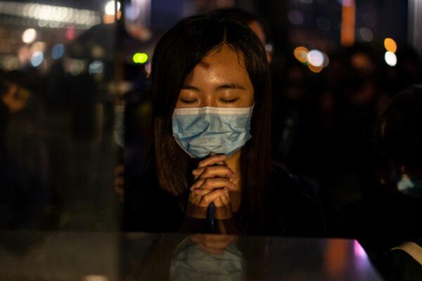 People take a moment of silence during a remembrance prayer in memory of university student Alex Chow in Hong Kong, on Nov. 9, 2019. (Anthony Kwan/Getty Images)
