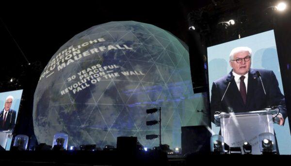 German President Frank-Walter Steinmeier is seen on giant video screens as he delivers a speech in front of the Brandenburg Gate as part of stage presentations to celebrate the 30th anniversary of the fall of the Berlin Wall in Berlin, Germany, on Nov. 9, 2019. (Michael Sohn/AP Photo)