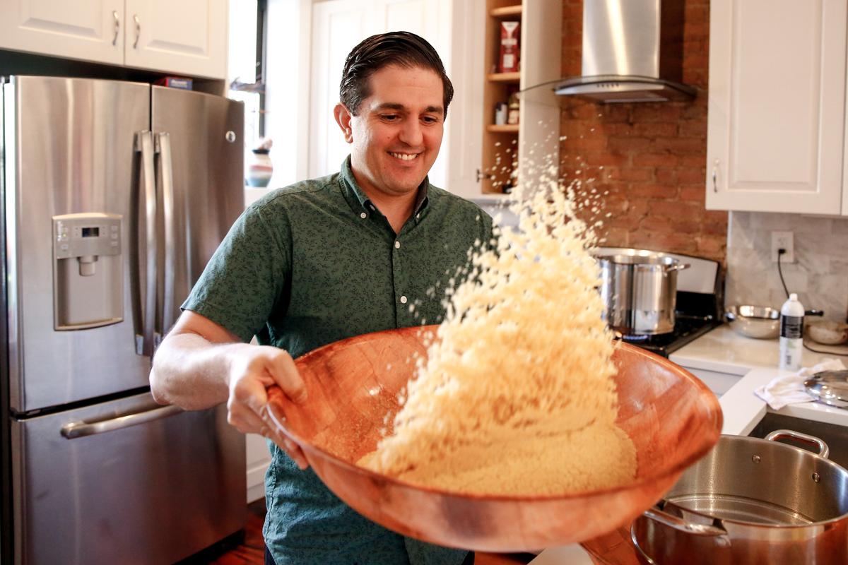 Ron Arazi gives a lesson in hand-rolled couscous in his home kitchen. (Samira Bouaou/The Epoch Times)