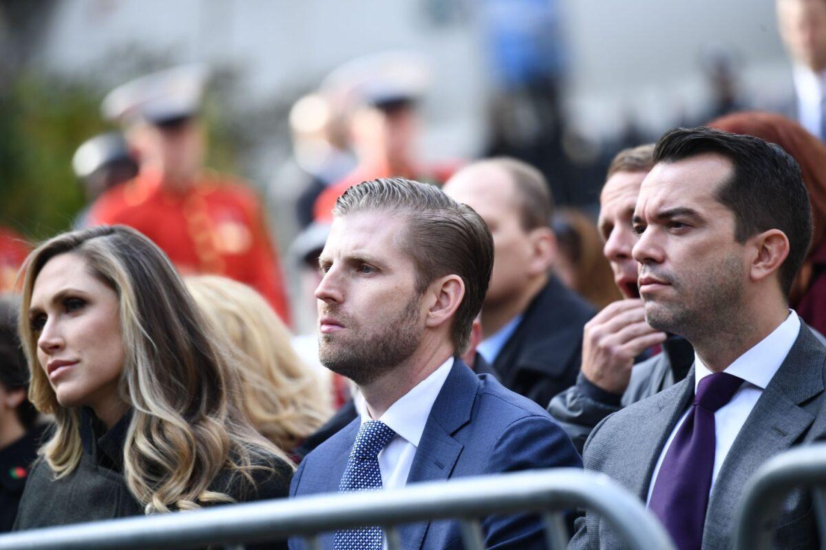 Eric Trump (C) and his wife Lara (L) listen as President Donald Trump delivers remarks at the New York City Veterans Day Parade on Nov. 11, 2019. (Brendan Smialowski/AFP via Getty Images)