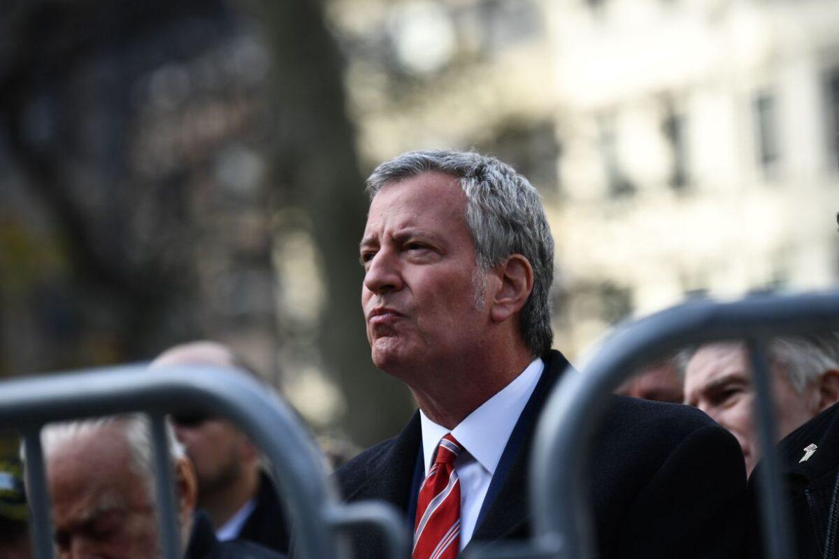 New York Mayor Bill de Blasio listens as President Donald Trump delivers remarks at the New York City Veterans Day Parade on Nov 11, at 2019. (Brendan Smialowski/AFP via Getty Images)
