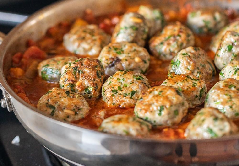 Meatballs nestled in their sauce, ready to simmer. (Maria Midoes for New York Shuk)