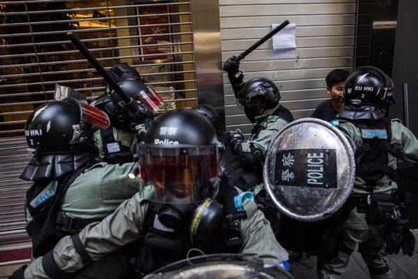 Riot police detain two men in the Central district of Hong Kong on Nov. 11, 2019. (Dale de la Rey/AFP via Getty Images)