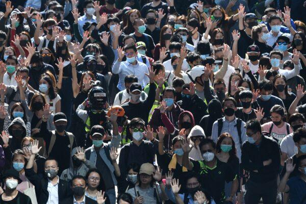Marching protesters hold up their hands as a symbol of the five demands of the movement, during a protest in Hong Kong's Central district on Nov. 11, 2019. (Anthony Wallace/AFP via Getty Images)