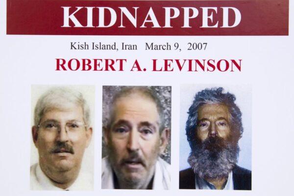 FBI poster showing a composite image of former FBI agent Robert Levinson (R) of how he would look like now after five years in captivity; an image (C) taken from the video, released by his kidnappers; and a picture before he was kidnapped, displayed during a news conference in Washington in March 6, 2012. (Manuel Balce Ceneta/AP)