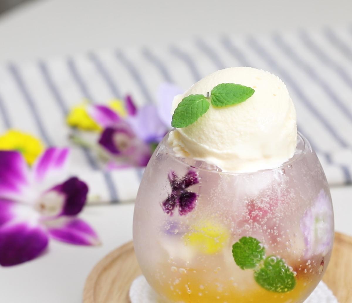 Yuja gingerade float with edible flower ice cubes. (NTD)