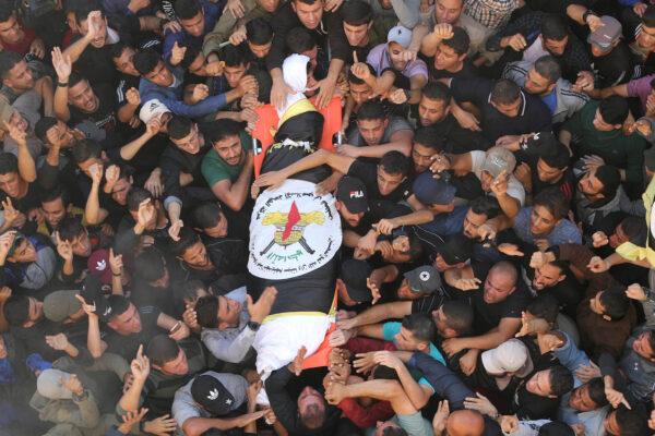 Mourners carry the body of Palestinian Islamic Jihad field commander Baha Abu Al-Atta during his funeral in Gaza City on Nov. 12, 2019. (Mohammed Salem/Reuters)