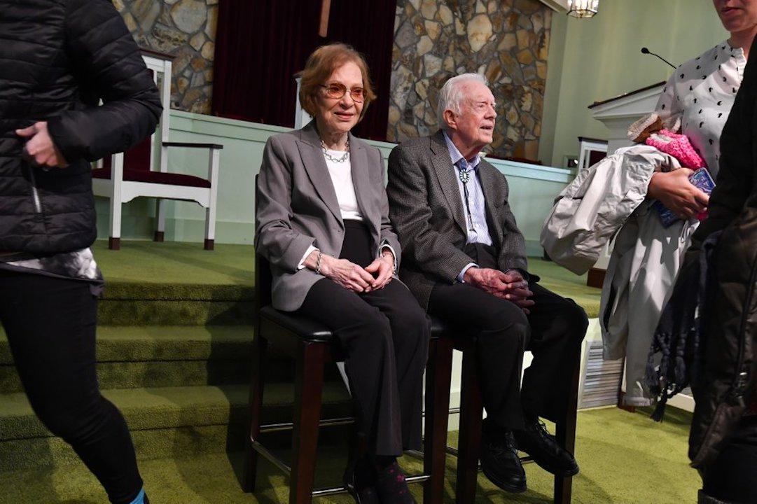 Former U.S. President Jimmy Carter and former first lady Rosalynn Carter, left, sit as guests of Maranatha Baptist Church come and go to have their photo made with them, after Jimmy taught Sunday school there, in Plains, Ga, on Nov. 3, 2019. (John Amis/AP)