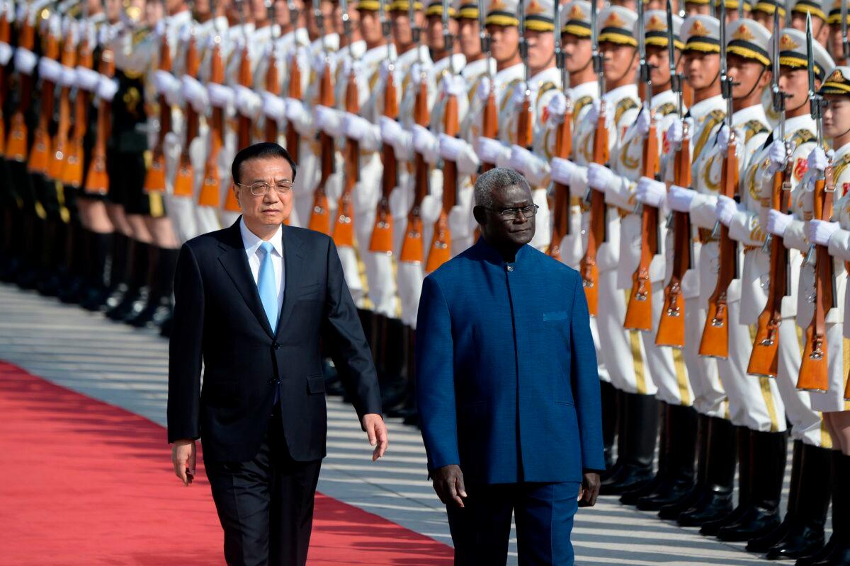 Solomon Islands Prime Minister Manasseh Sogavare (R) and Chinese Premier Li Keqiang inspect honor guards during a welcome ceremony at the Great Hall of the People in Beijing, China, on Oct. 9, 2019. (Wang Zhao/AFP via Getty Images)