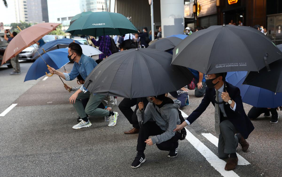 People use umbrellas to take cover during an anti-government demonstration in the Central district of Hong Kong on Nov. 13, 2019. (Athit Perawongmetha/Reuters)