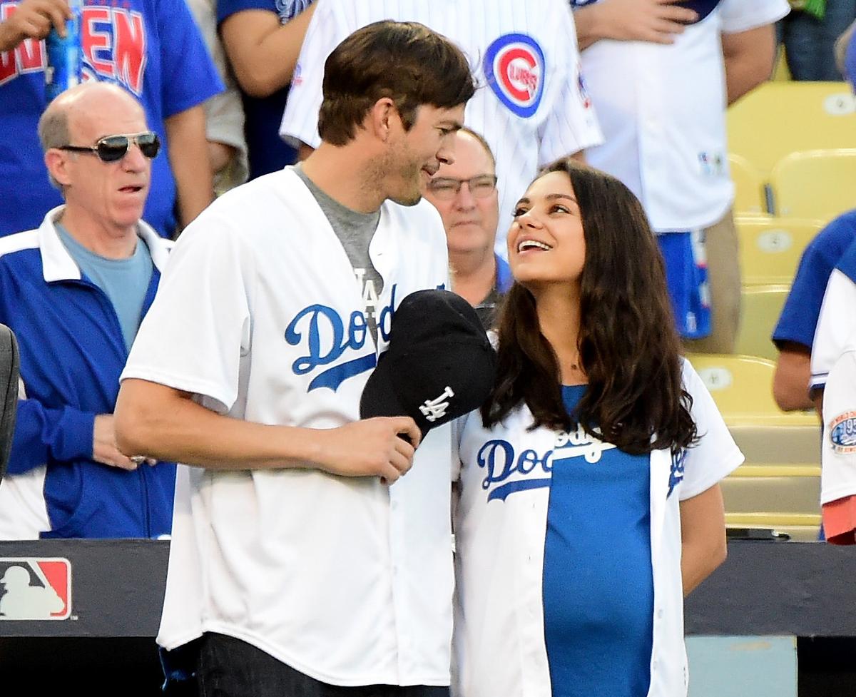 Kutcher and Kunis after announcing the Los Angeles Dodgers starting lineup at Dodger Stadium in L.A. on Oct. 19, 2016 (©Getty Images | <a href="https://www.gettyimages.com.au/detail/news-photo/ashton-kutcher-and-wife-mila-kunis-on-the-field-after-they-news-photo/615688522">Harry How</a>)