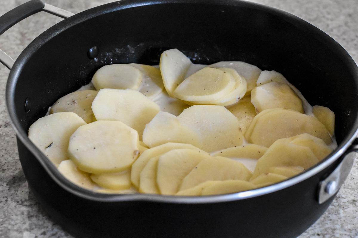 Simmering the potatoes with milk and cream. (Audrey Le Goff)