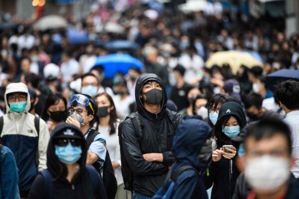 Office workers and pro-democracy protesters gather during a demonstration in Central in Hong Kong on Nov. 12, 2019. (Anthony Wallace/AFP via Getty Images)
