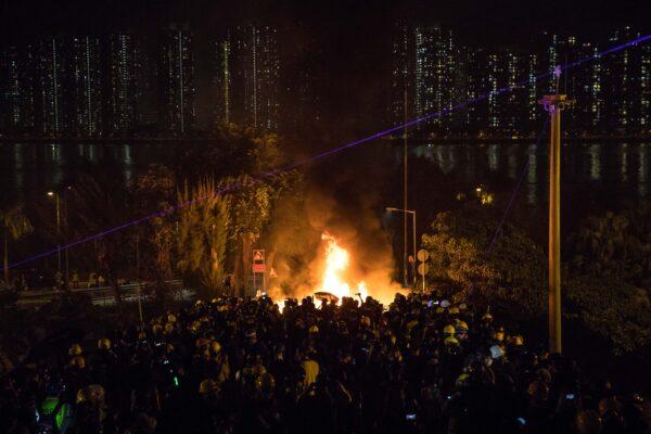Protesters gather on a bridge as a barricade burns after clashes with police at the Chinese University of Hong Kong (CUHK) in Hong Kong on Nov. 12, 2019. (Dale de la Rey/AFP via Getty Images)