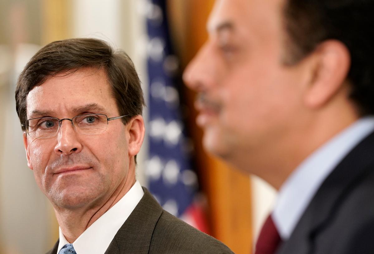 U.S. Secretary of Defense Mark Esper (L) answers questions briefly with Qatari Minister of State for Defense Affairs Khalid Al-Attiyah (R) at the Pentagon in Arlington, Virginia, on Nov. 6, 2019. (Win McNamee/Getty Images)