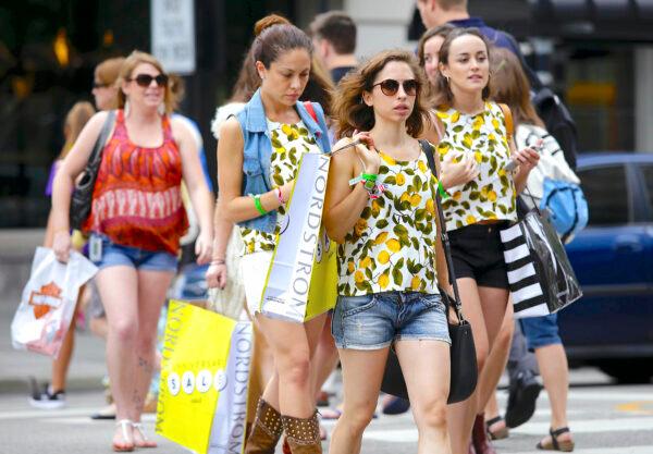 Consumers hold shopping bags on Michigan Avenue in Chicago on July 29, 2016. (Joshua Lott/Getty Images)