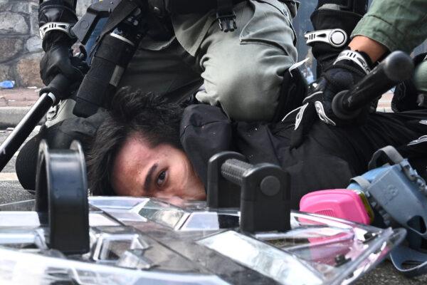 A man is detained after police fired tear gas at the Chinese University of Hong Kong (CUHK), in Hong Kong on Nov. 12, 2019. (Philip Fong/AFP via Getty Images)