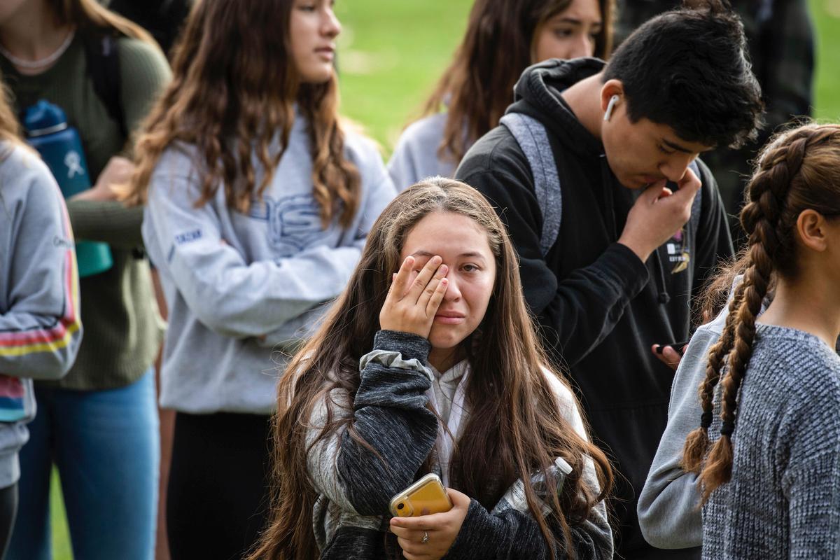 Students wait to reunite with their families at Central Park following a shooting that injured several people at Saugus High School, in Santa Clarita, Calif. on Nov. 14, 2019. (Sarah Reingewirtz/The Orange County Register via AP)