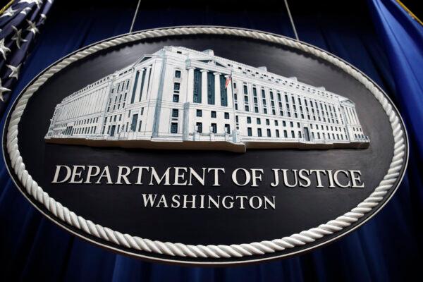 A sign for the Department of Justice hangs in the press briefing room at the Justice Department in Washington on April 18, 2019. (Patrick Semansky/AP Photo)