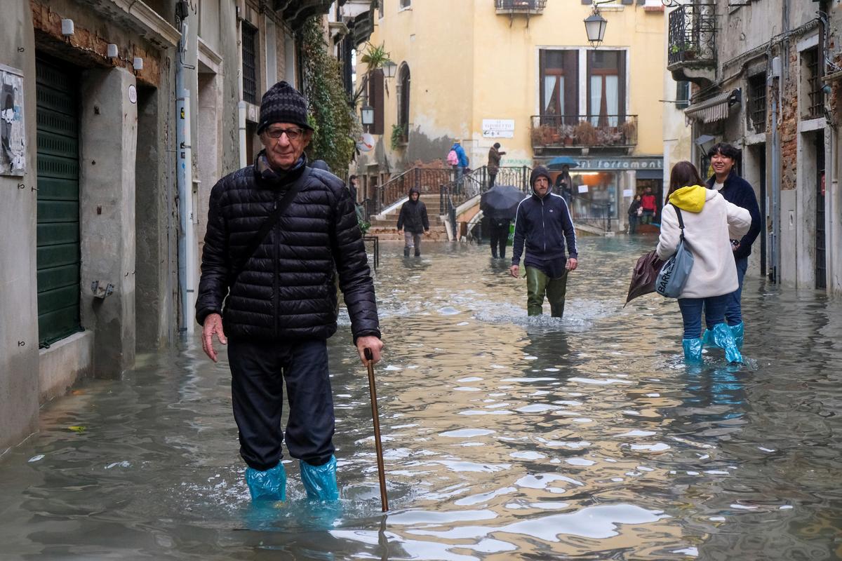People walk outside during exceptionally high water levels in Venice, Italy Nov. 13, 2019. (Reuters/Manuel Silvestri)
