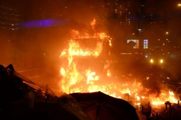 An armored truck was caught on fire during clashes at the Polytechnic University of Hong Kong in Hung Hom district of Hong Kong on Nov. 17, 2019. (Sung Pi Lung/The Epoch Times)
